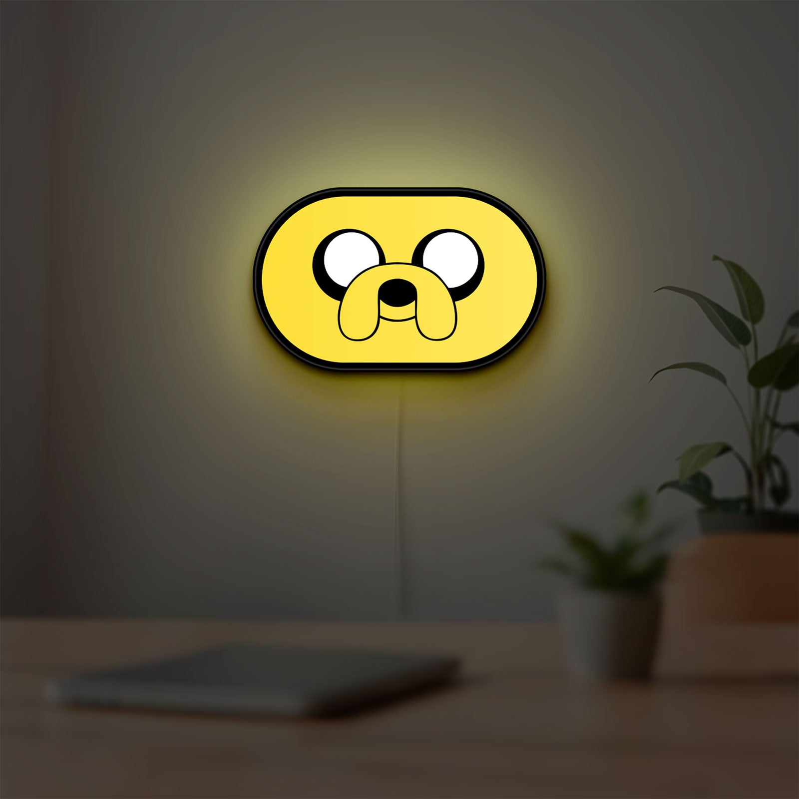 Adventure Time Jake LED lightbox hanging on a room wall with soft yellow light