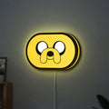 Adventure Time Jake LED lightbox hanging on a wall with yellow glow