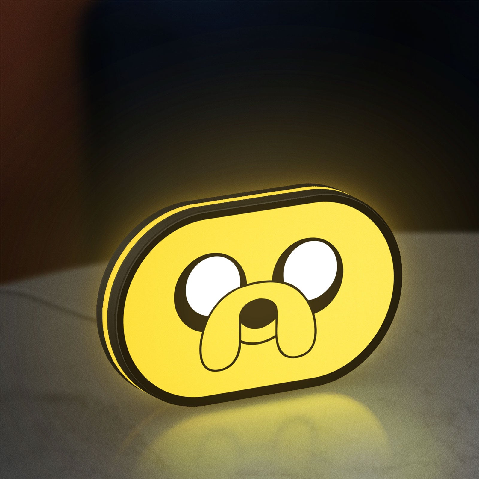 Adventure Time Jake LED lightbox standing on a desk from an angled side view with yellow glow
