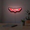 Disney Planes LED lightbox hanging on a room wall with soft red light