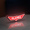 Disney Planes LED lightbox standing on a desk from an angled side view with red glow