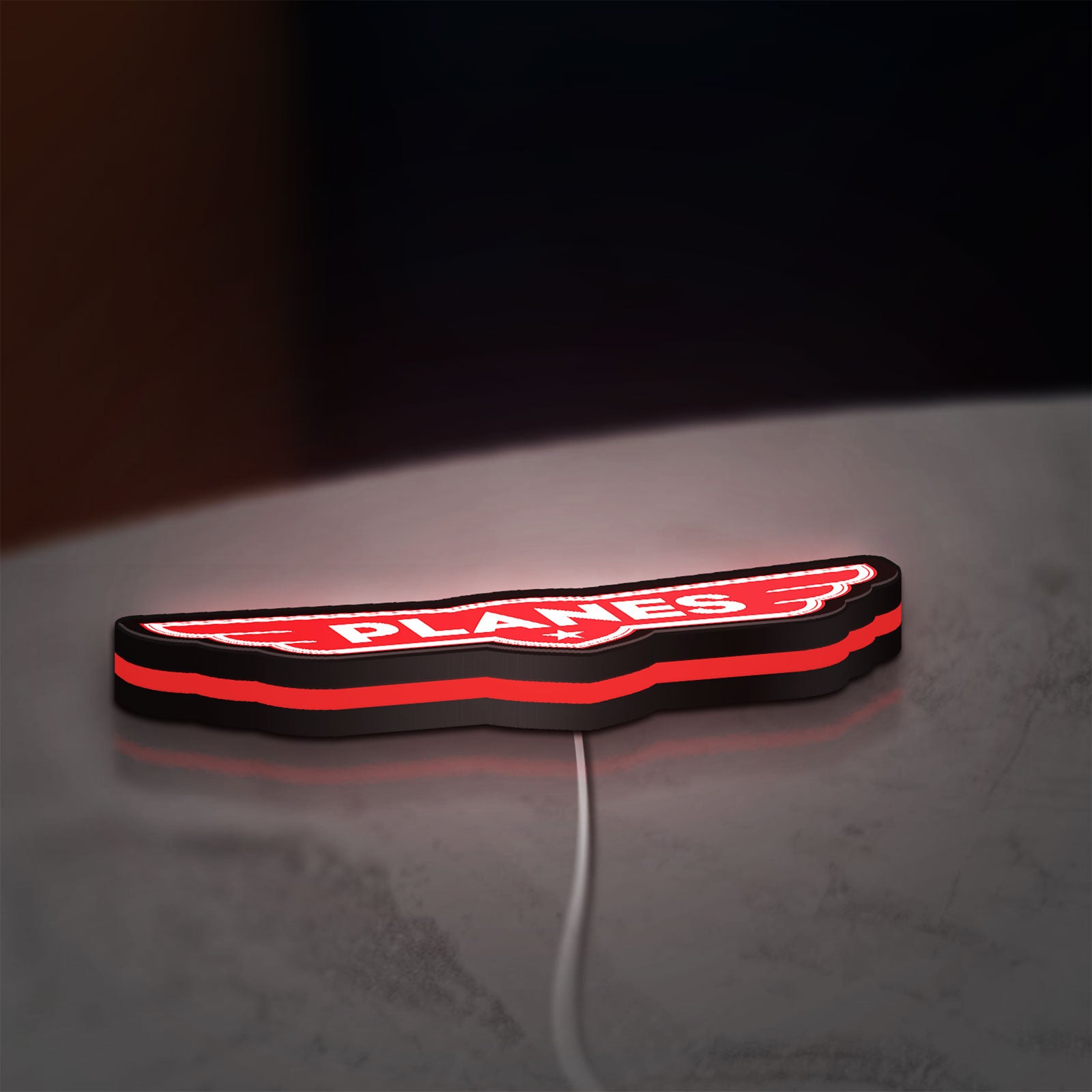 Disney Planes LED lightbox lying flat on a desk with red glow