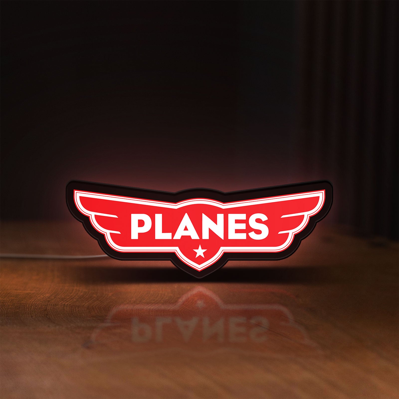 Front view of Disney Planes LED lightbox sign glowing on a wooden desk