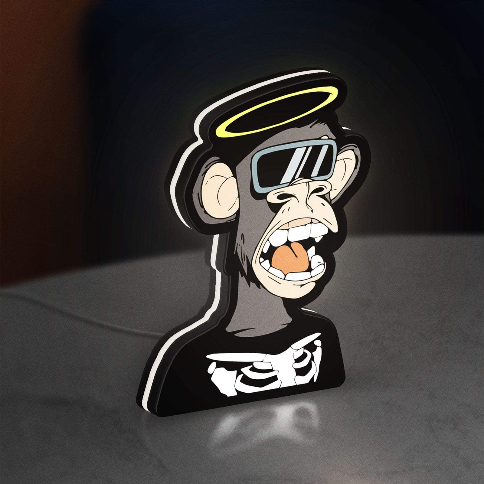Bored Ape NFT LED lightbox standing on a desk from an angled side view with white glow