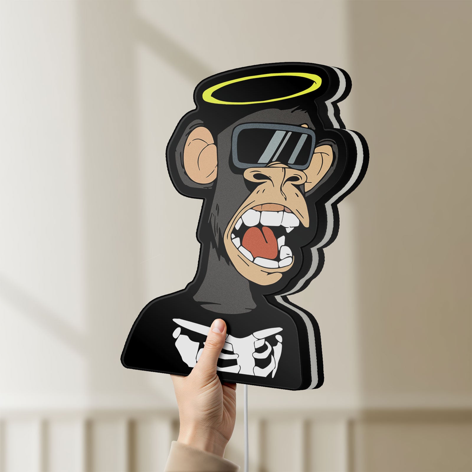 Unlit Bored Ape NFT LED lightbox held by hand to show size and details
