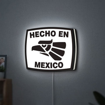 Hecho en Mexico LED lightbox hanging on a wall with white glow