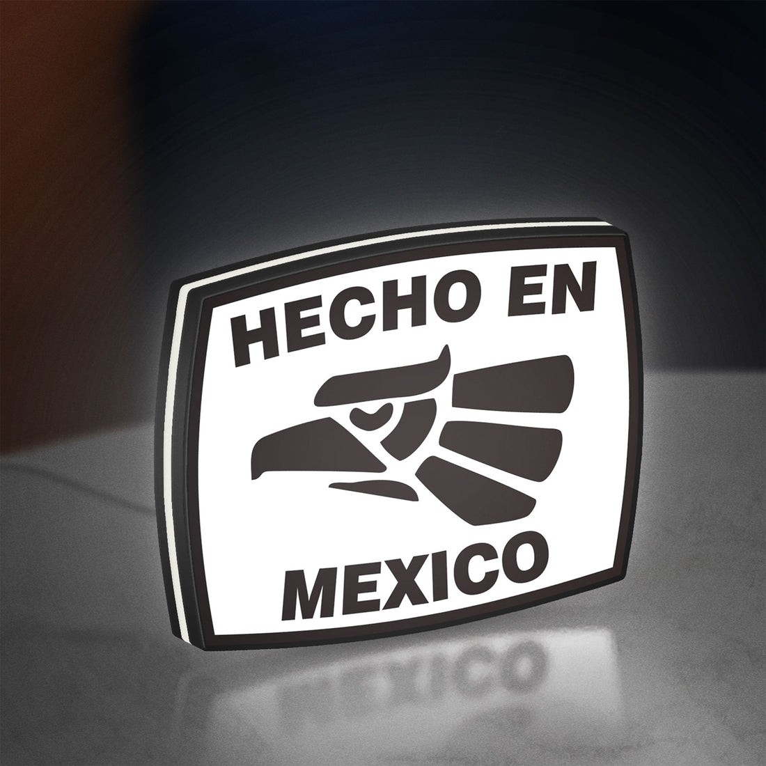 Hecho en Mexico LED lightbox hanging on a wall with white glow