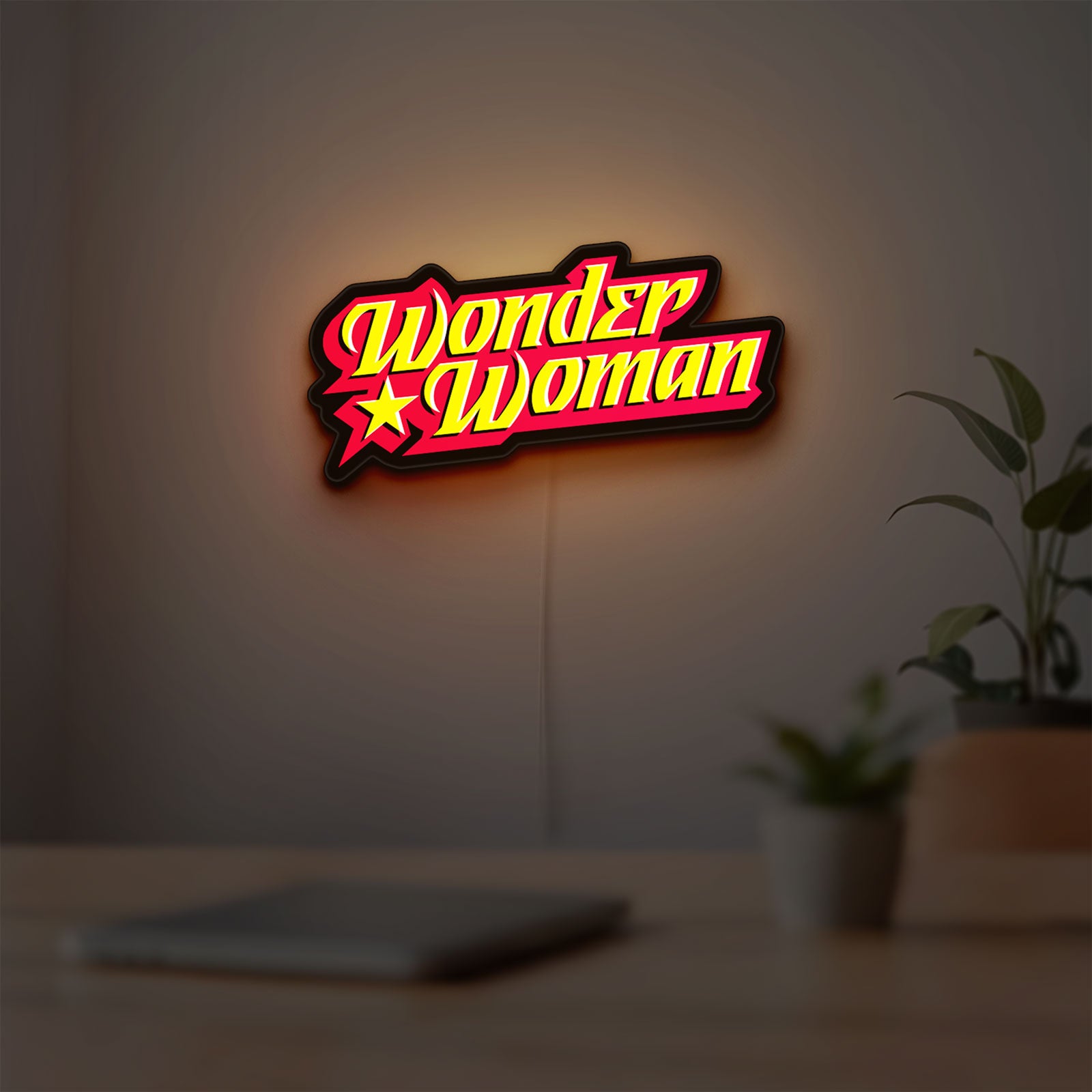 Wonder Woman LED lightbox hanging on a room wall with soft red light