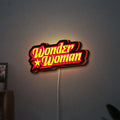 Wonder Woman LED lightbox hanging on a wall with red glow