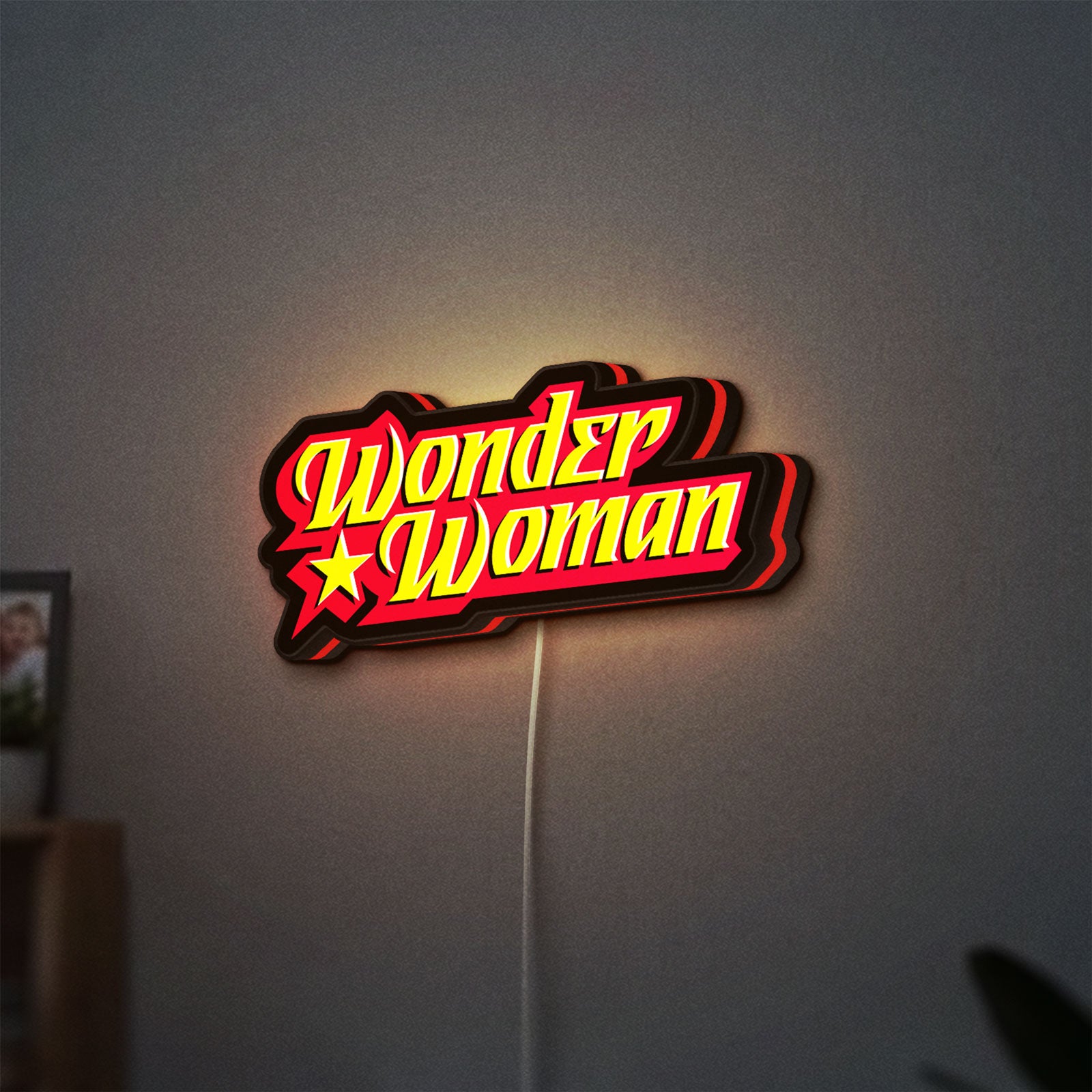 Wonder Woman LED lightbox hanging on a wall with red glow