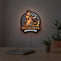 Motocross LED lightbox hanging on a room wall with soft white light