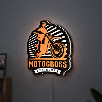 Motocross LED lightbox hanging on a wall with white glow