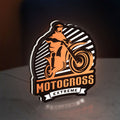 Motocross LED lightbox standing on a desk from an angled side view with white glow