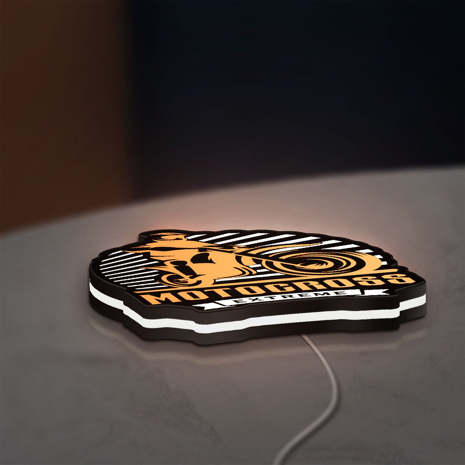 Motocross LED lightbox lying flat on a desk with white glow