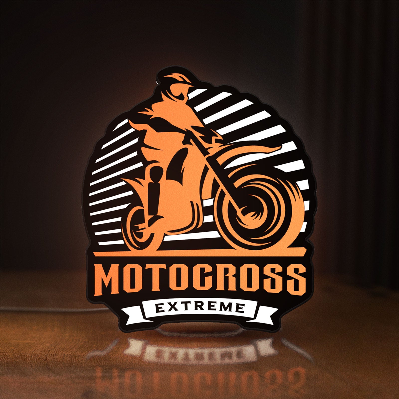 Front view of Motocross LED lightbox sign glowing on a wooden desk