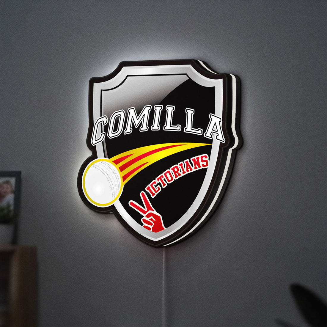Comilla Victorians LED lightbox hanging on a wall with white glow