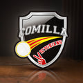 Front view of Comilla Victorians LED lightbox sign glowing on a wooden desk