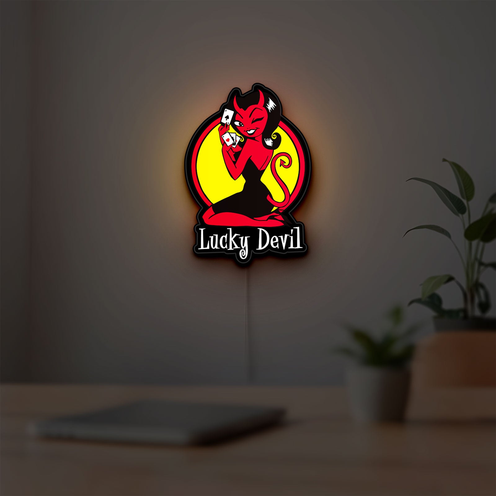 Lucky Devil LED lightbox hanging on a room wall with soft red light