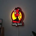 Lucky Devil LED lightbox hanging on a wall with red glow