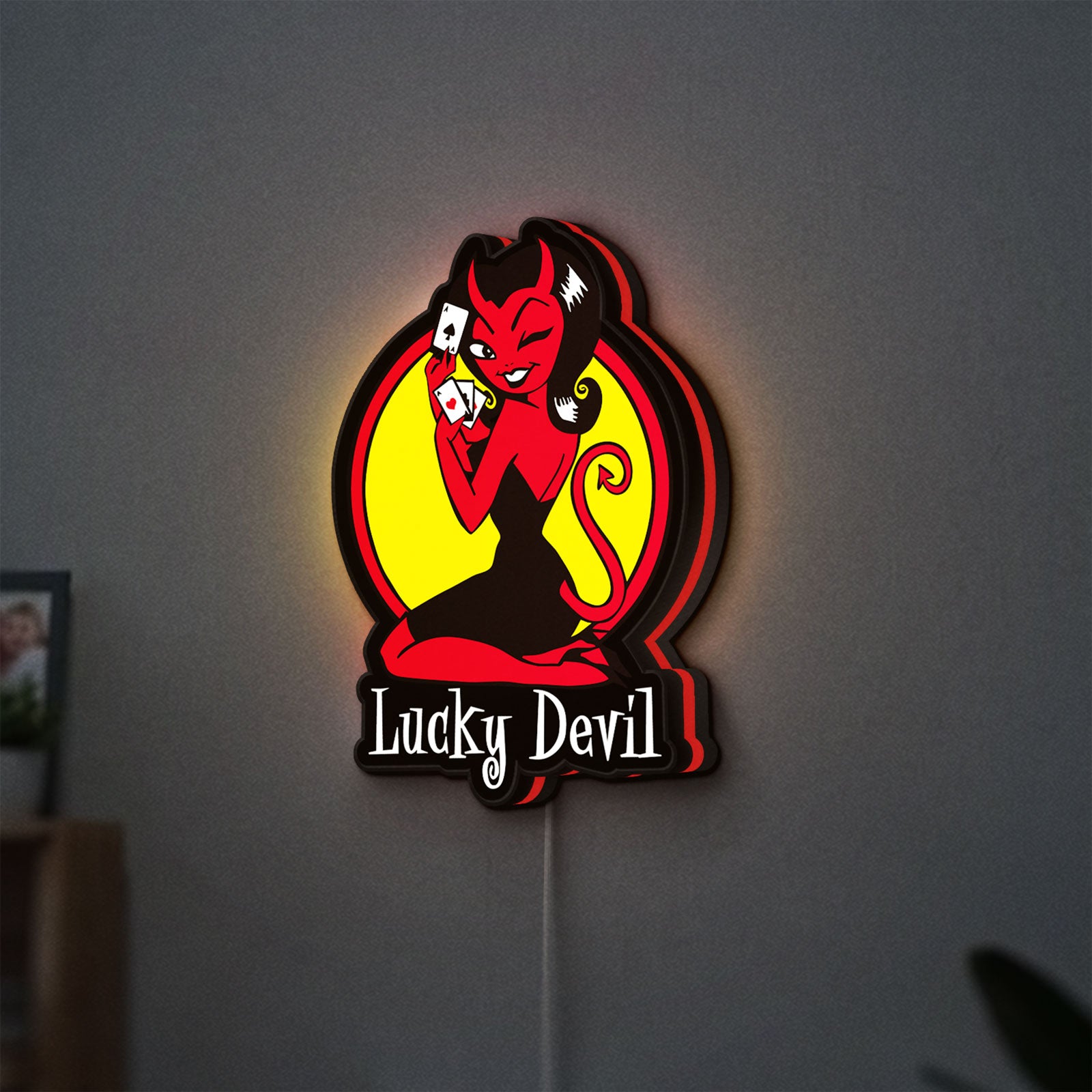 Lucky Devil LED lightbox hanging on a wall with red glow