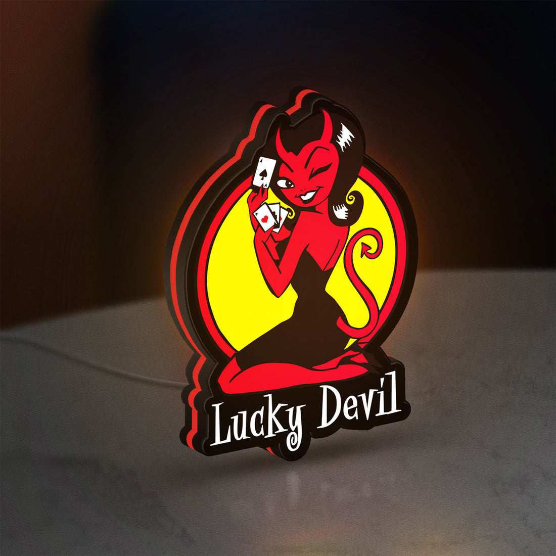 Lucky Devil LED lightbox hanging on a wall with red glow