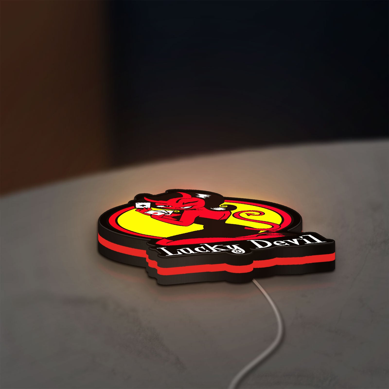 Lucky Devil LED lightbox lying flat on a desk with red glow