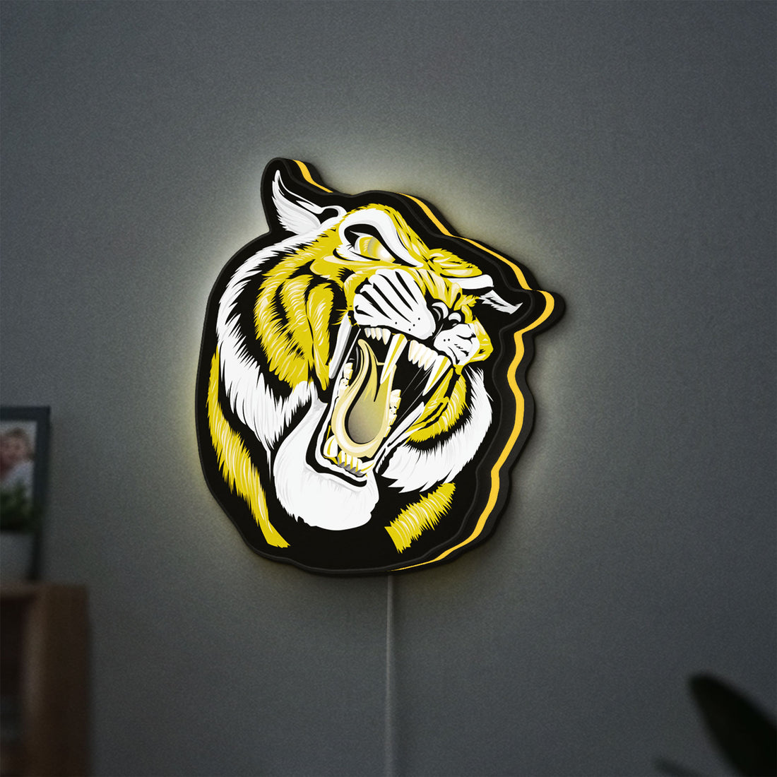 Tiger LED lightbox hanging on a wall with yellow glow