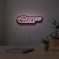 Power Puff Girls LED lightbox hanging on a room wall with soft pink light