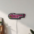 Unlit Power Puff Girls LED lightbox mounted on a wall in daylight