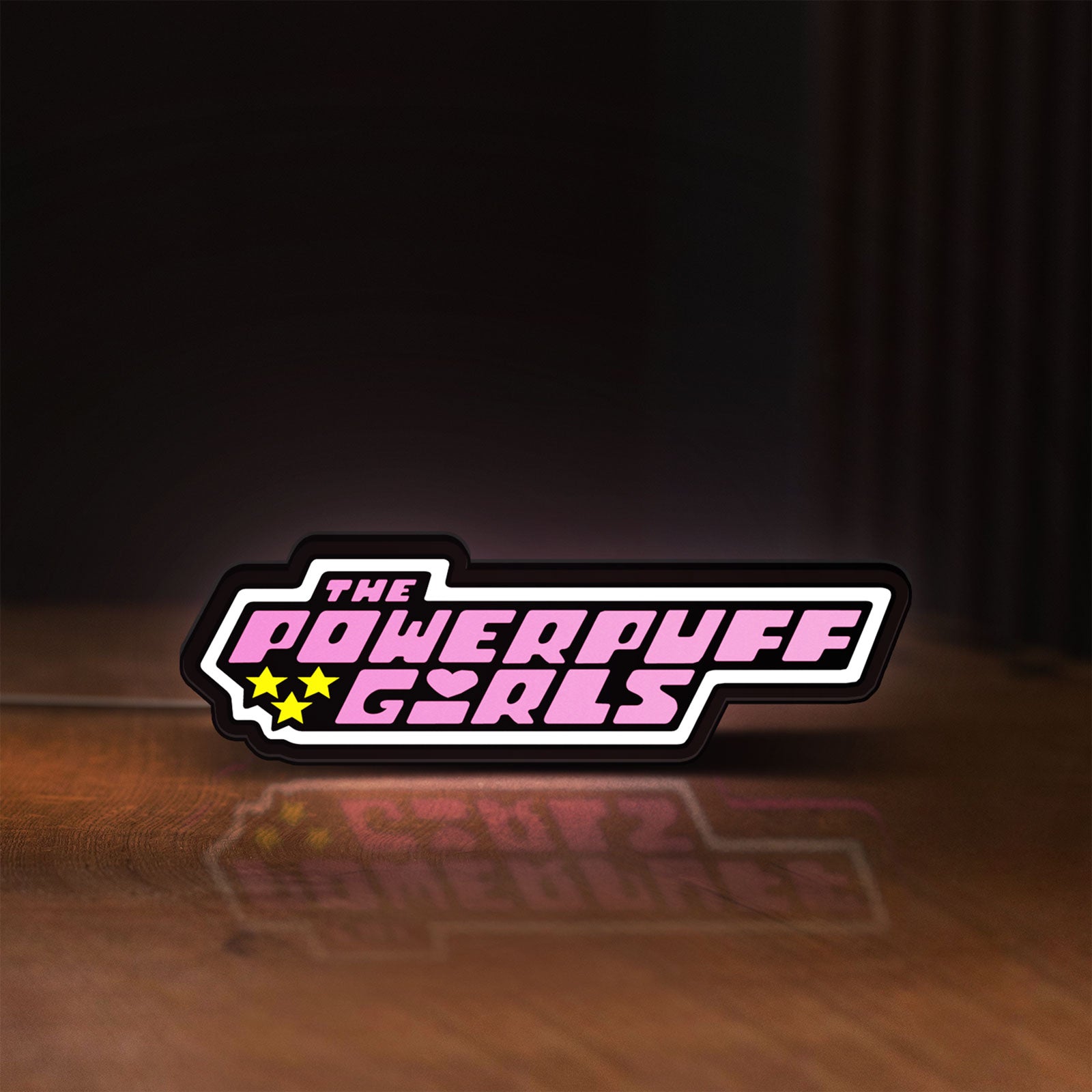 Front view of Power Puff Girls LED lightbox sign glowing on a wooden desk