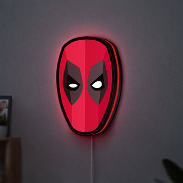 Deadpool Head LED lightbox hanging on a wall with red glow