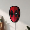 Unlit Deadpool Head LED lightbox mounted on a wall in daylight