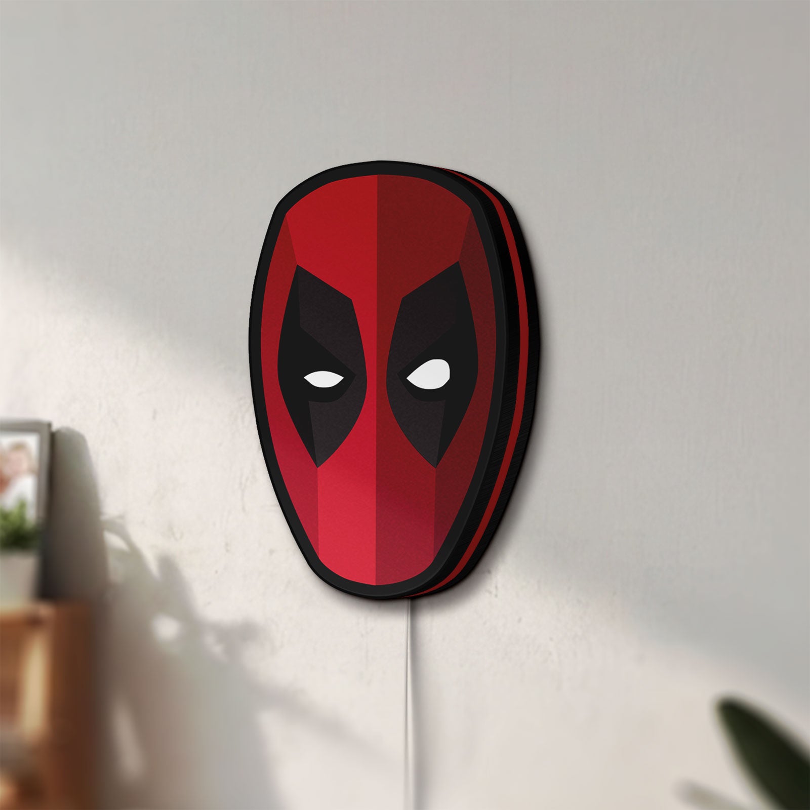 Unlit Deadpool Head LED lightbox mounted on a wall in daylight