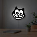 Felix the Cat LED lightbox hanging on a room wall with soft white light