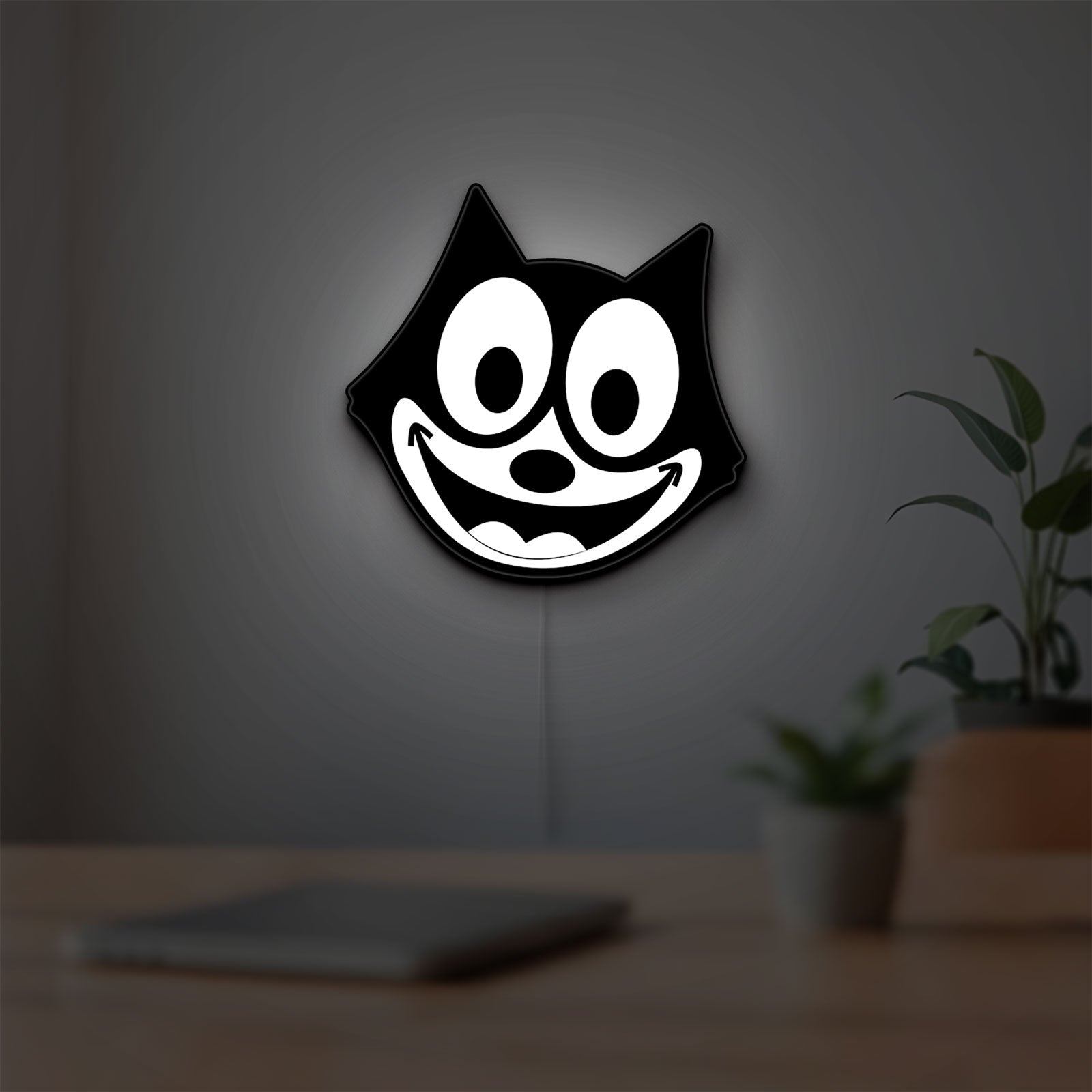 Felix the Cat LED lightbox hanging on a room wall with soft white light