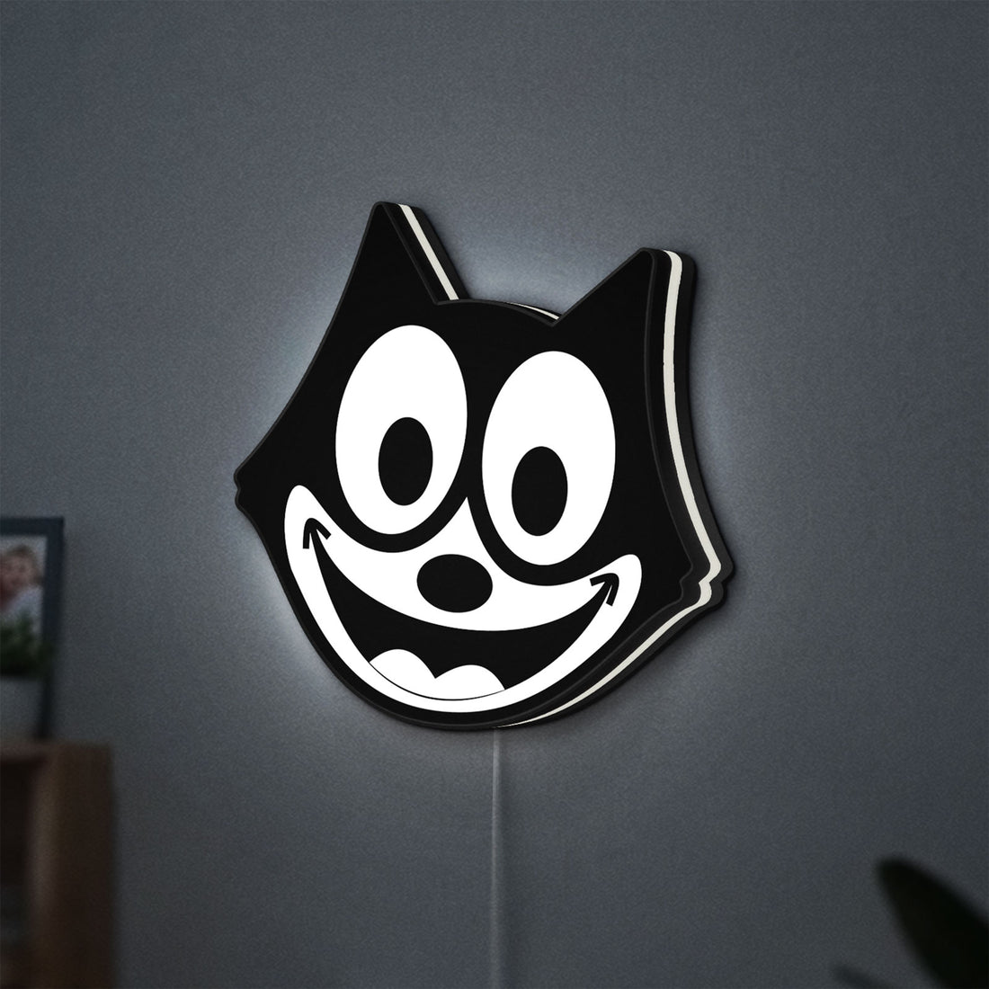 Felix the Cat LED lightbox hanging on a wall with white glow