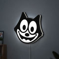 Felix the Cat LED lightbox hanging on a wall with white glow