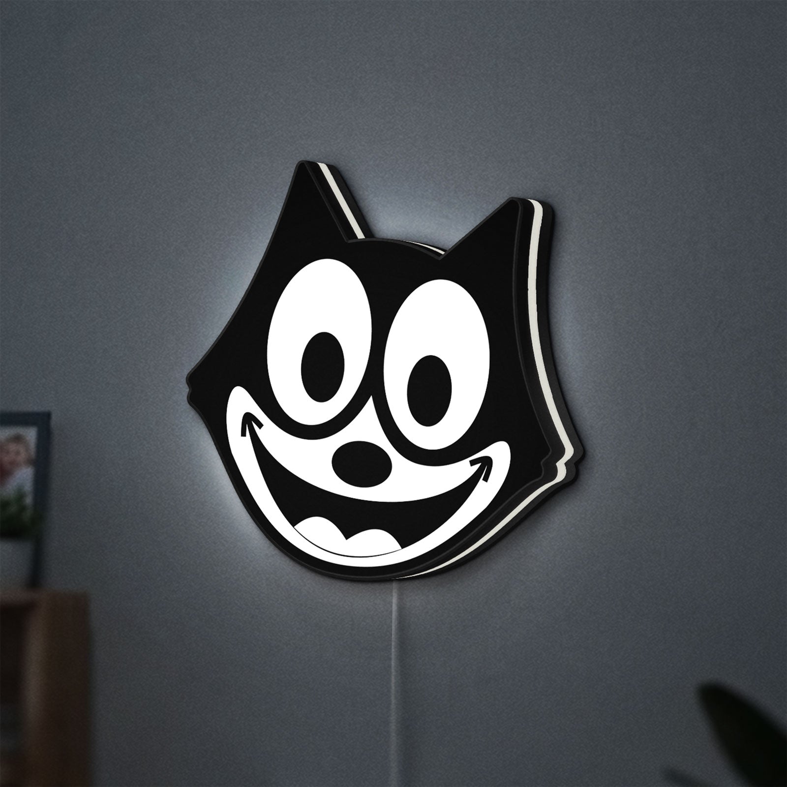 Felix the Cat LED lightbox hanging on a wall with white glow