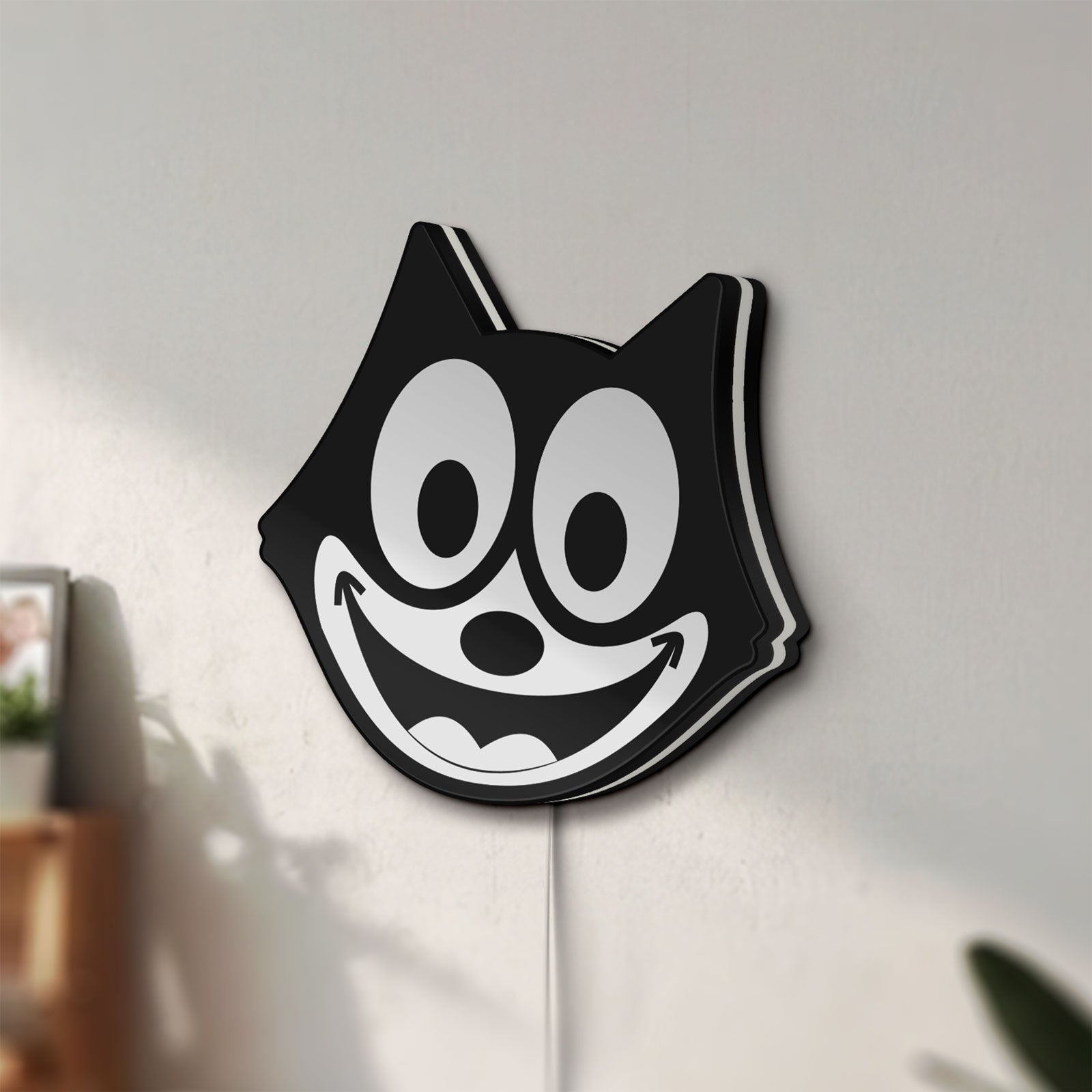 Unlit Felix the Cat LED lightbox mounted on a wall in daylight
