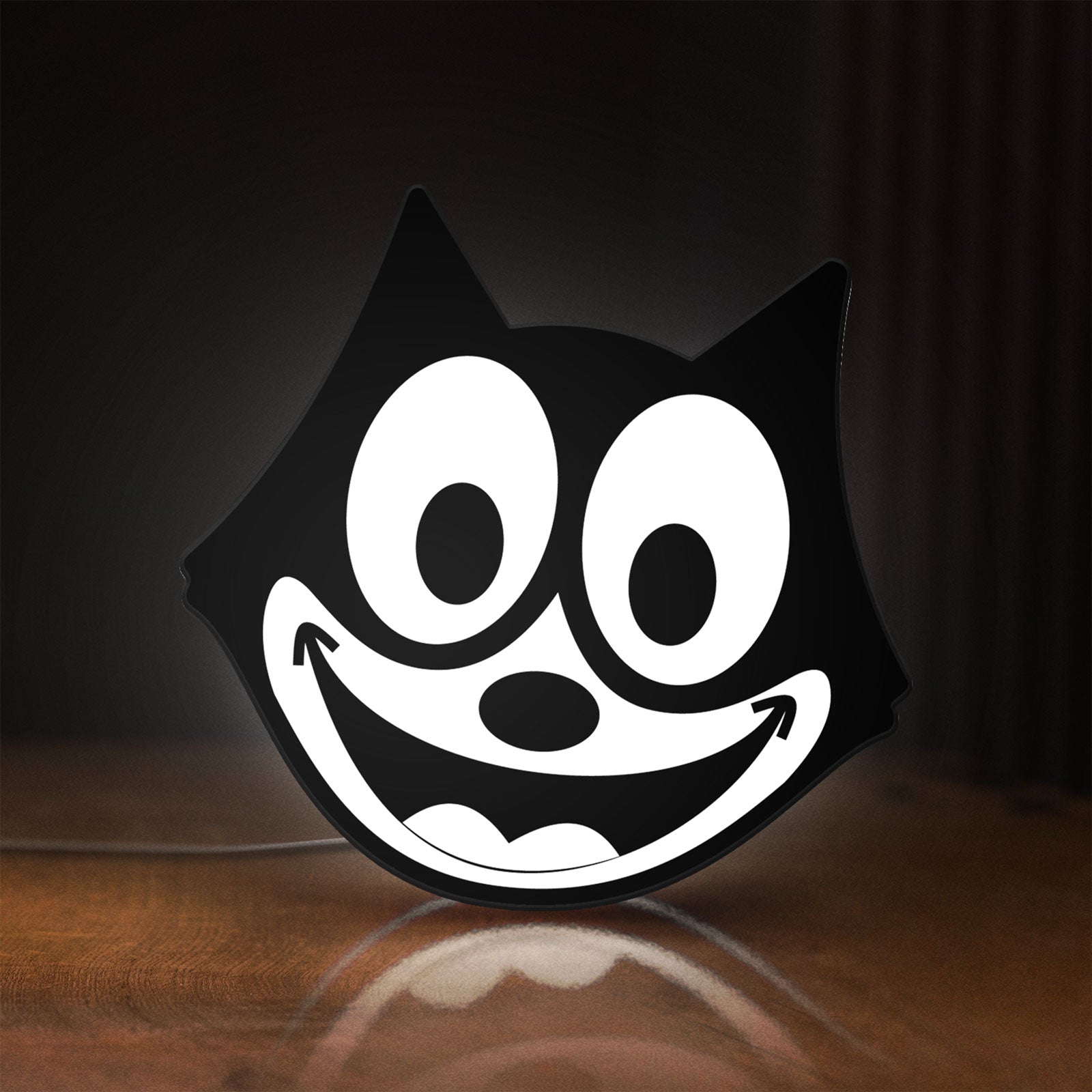 Front view of Felix the Cat LED lightbox sign glowing on a wooden desk