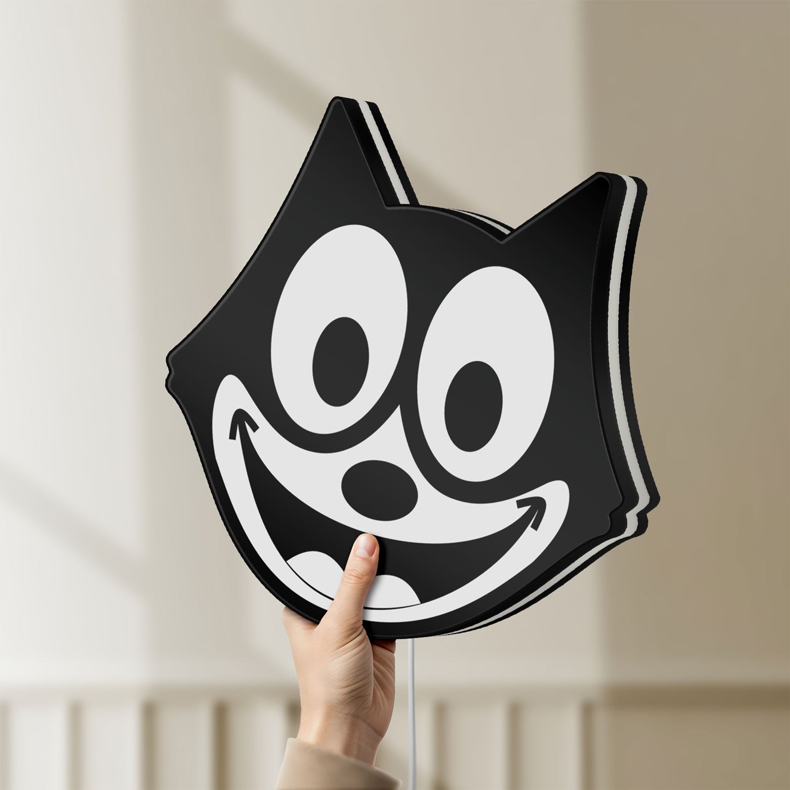 Unlit Felix the Cat LED lightbox held by hand to show size and details