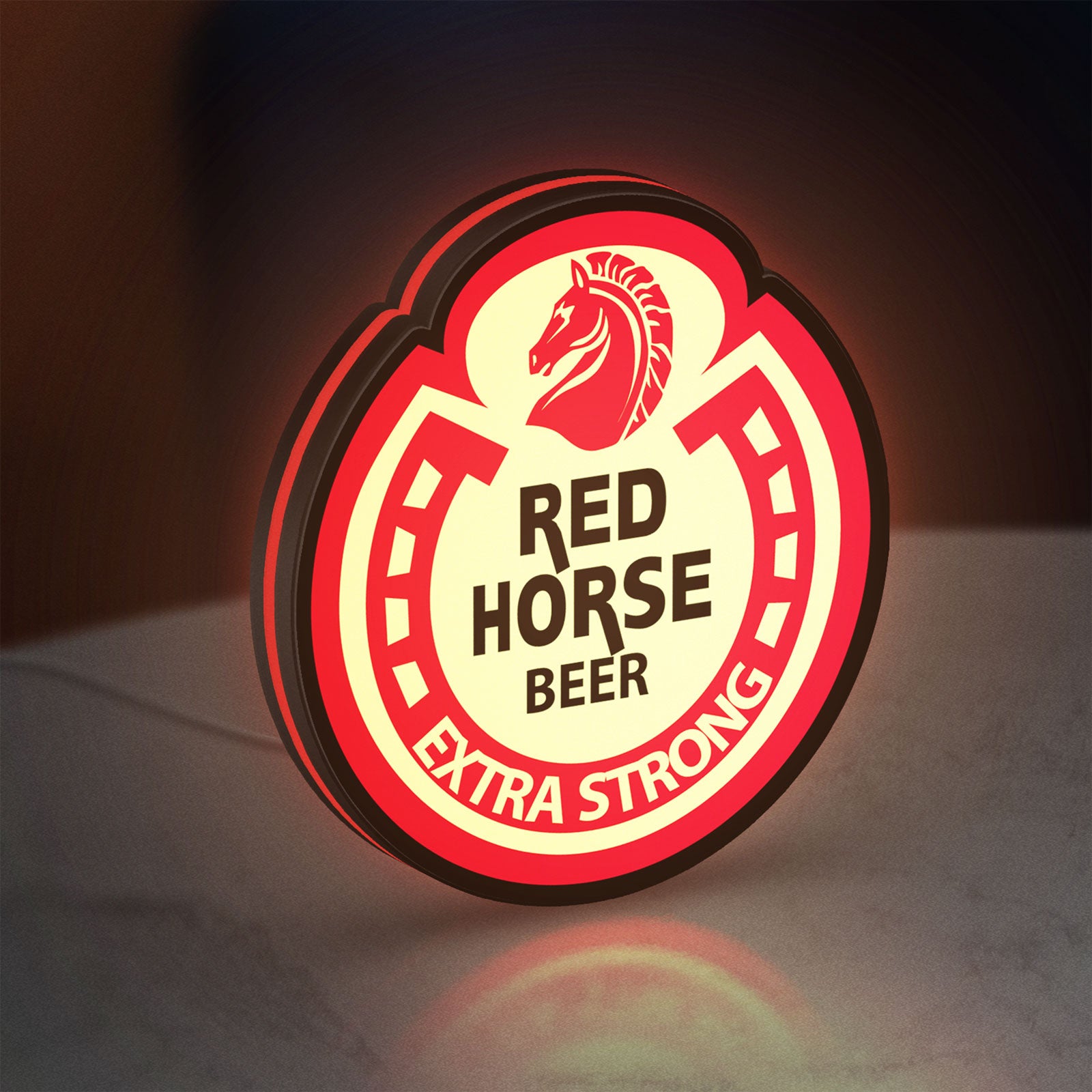 Red Horse Beer LED lightbox standing on a desk from an angled side view with red glow