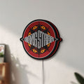 Unlit Gang Starr LED lightbox mounted on a wall in daylight