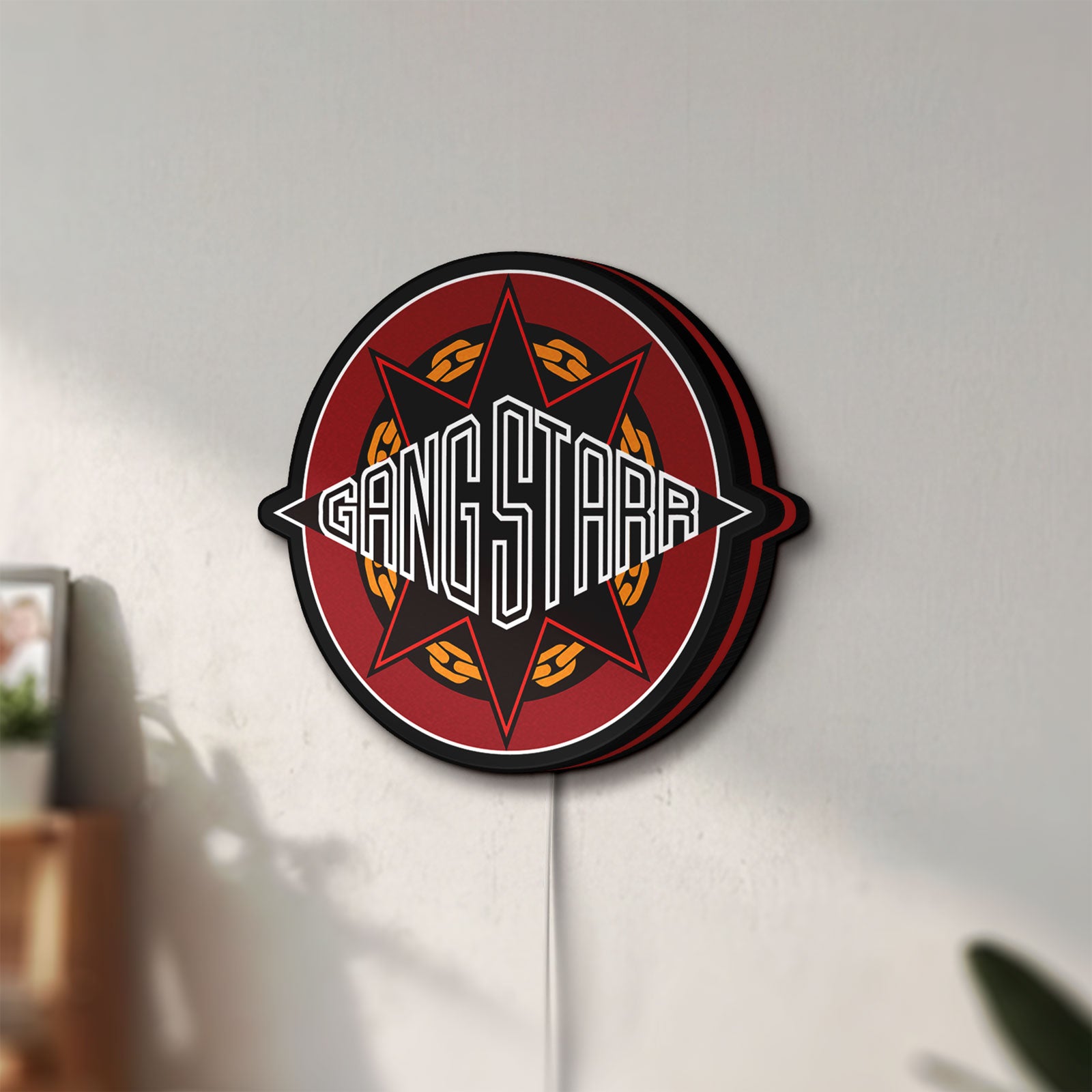 Unlit Gang Starr LED lightbox mounted on a wall in daylight
