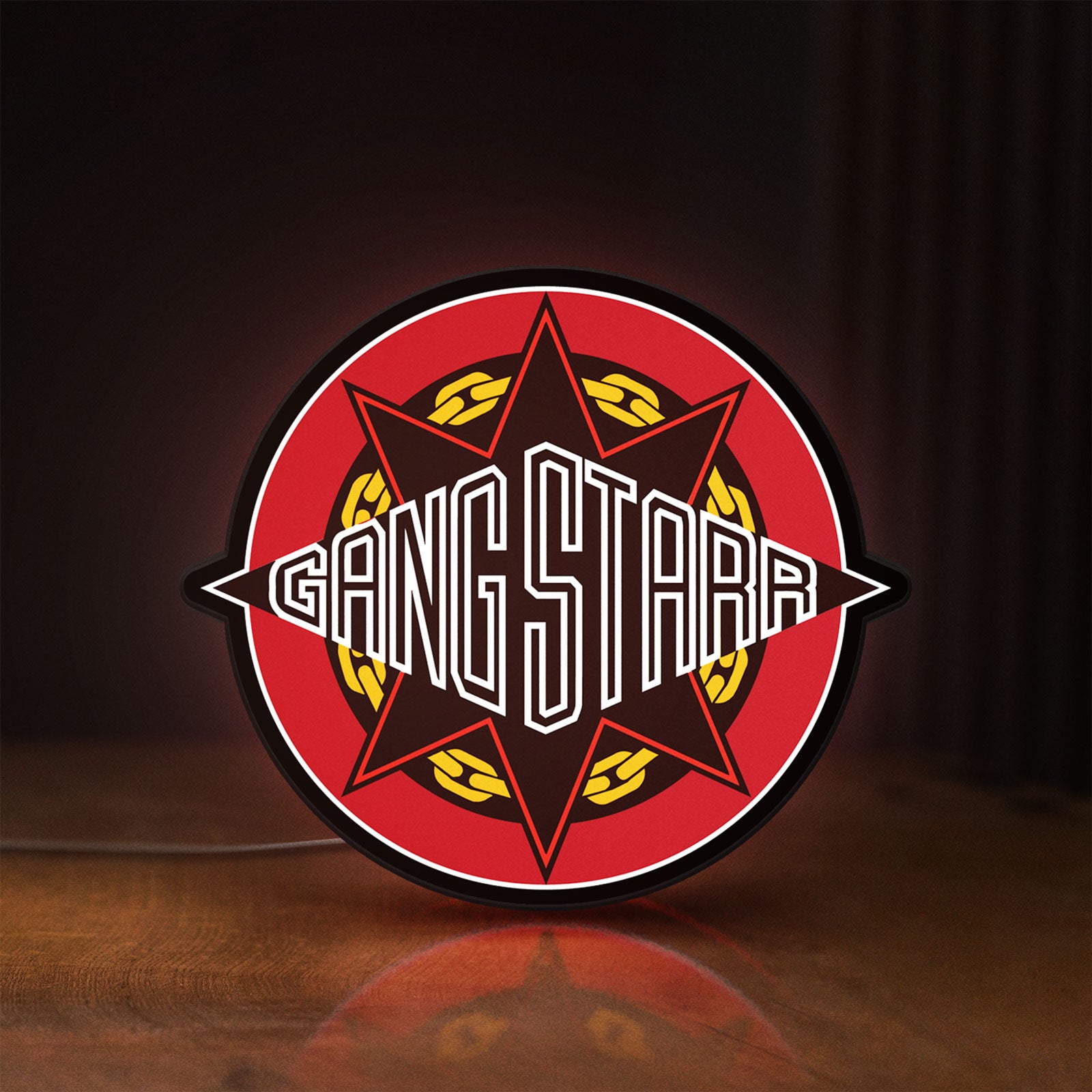 Front view of Gang Starr LED lightbox sign glowing on a wooden desk