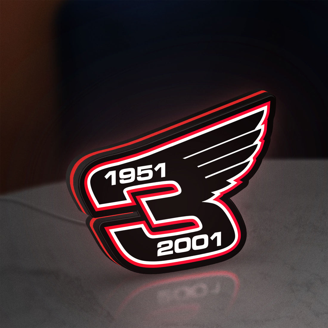 Dale Earnhardt Wings LED lightbox hanging on a wall with red glow
