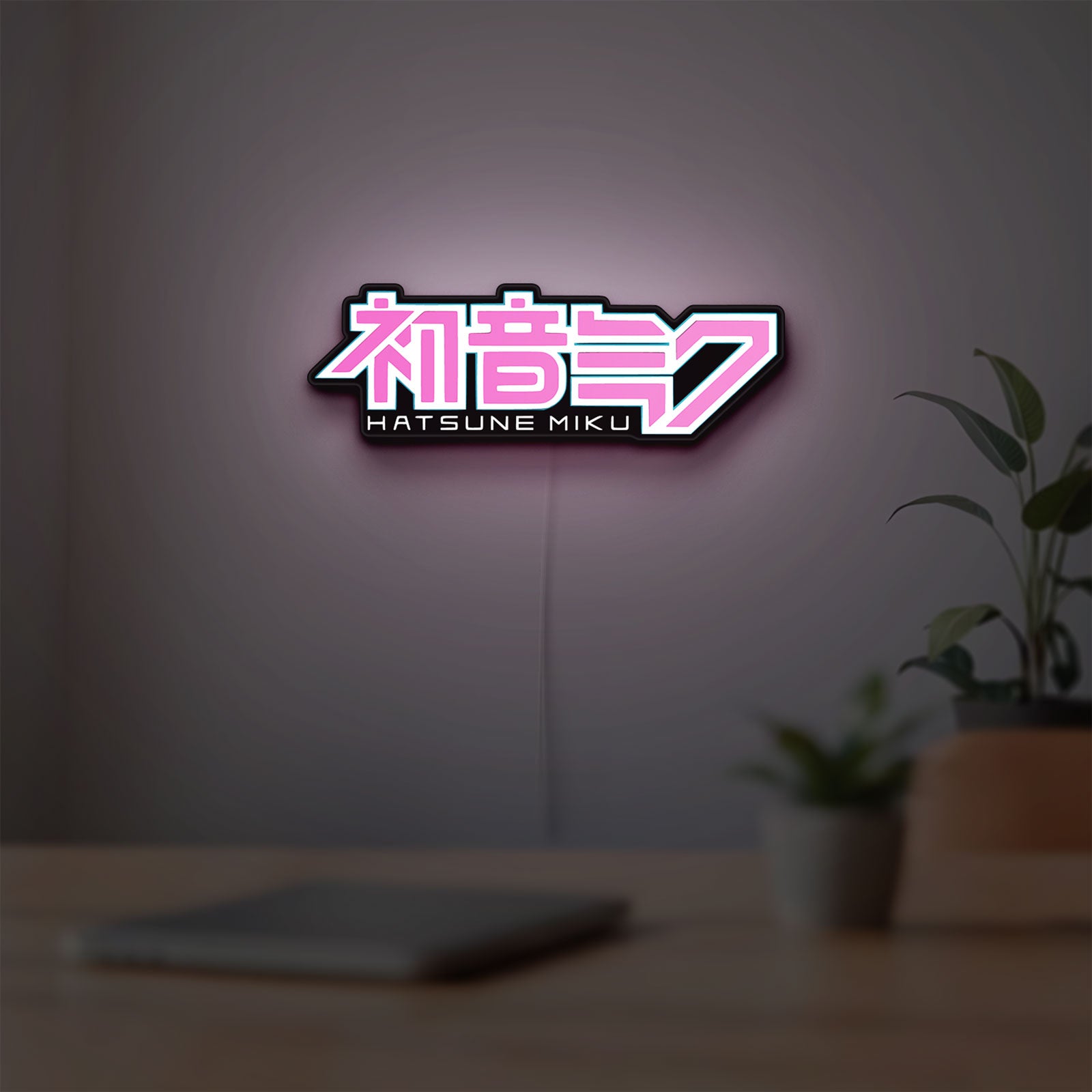 Hatsune Miku LED lightbox hanging on a room wall with soft pink light