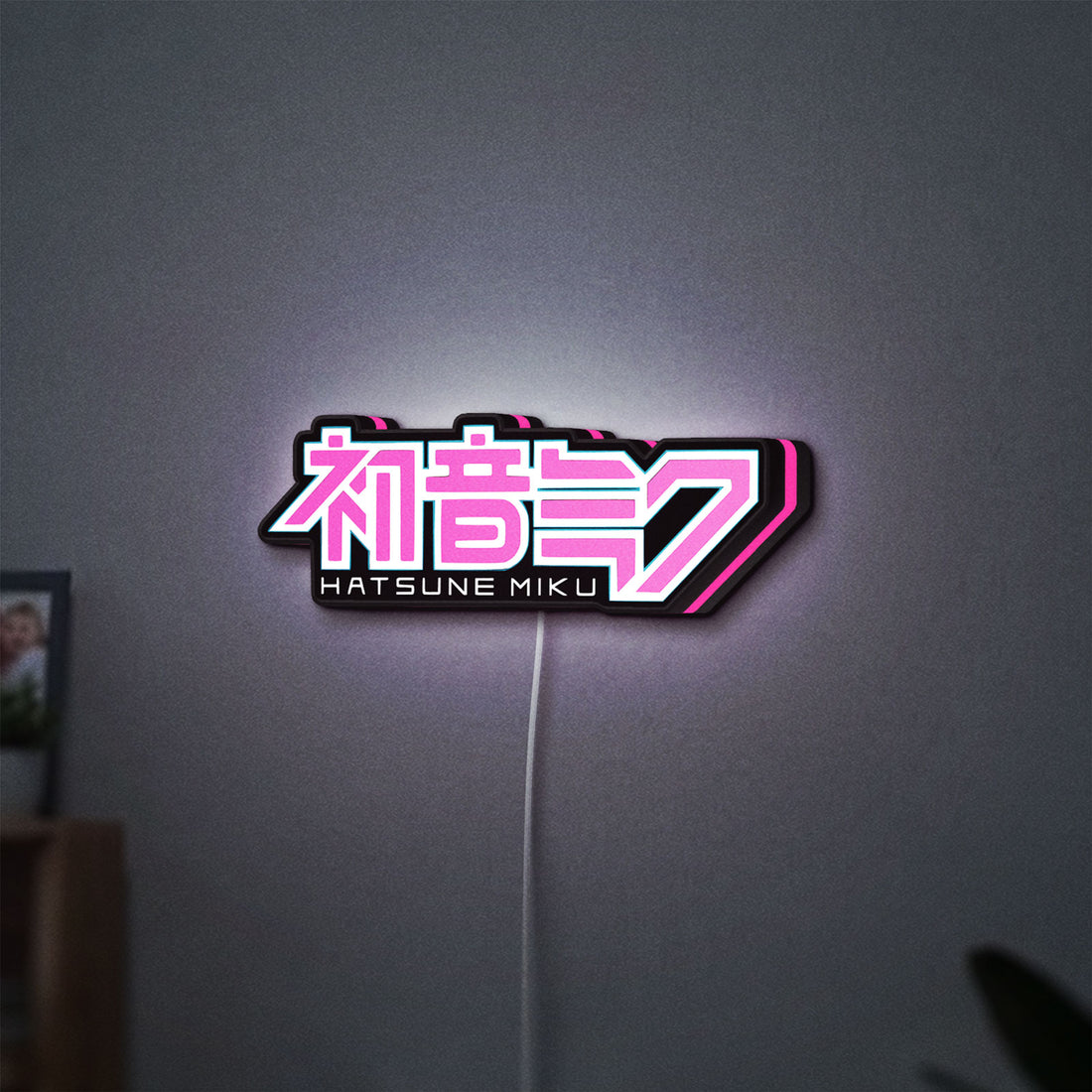 Hatsune Miku LED lightbox hanging on a wall with pink glow