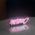 Hatsune Miku LED lightbox standing on a desk from an angled side view with pink glow