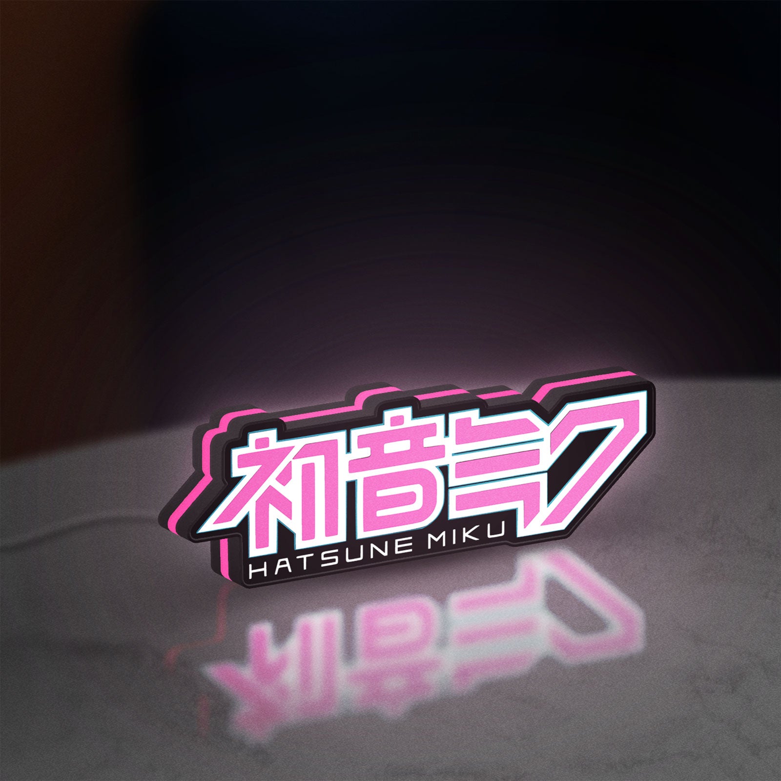 Hatsune Miku LED lightbox standing on a desk from an angled side view with pink glow